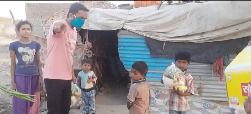 Children receiving vegetables and essential groceries